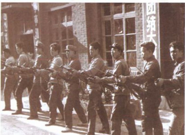 一群民兵在厂区拿着步枪进行军事训练